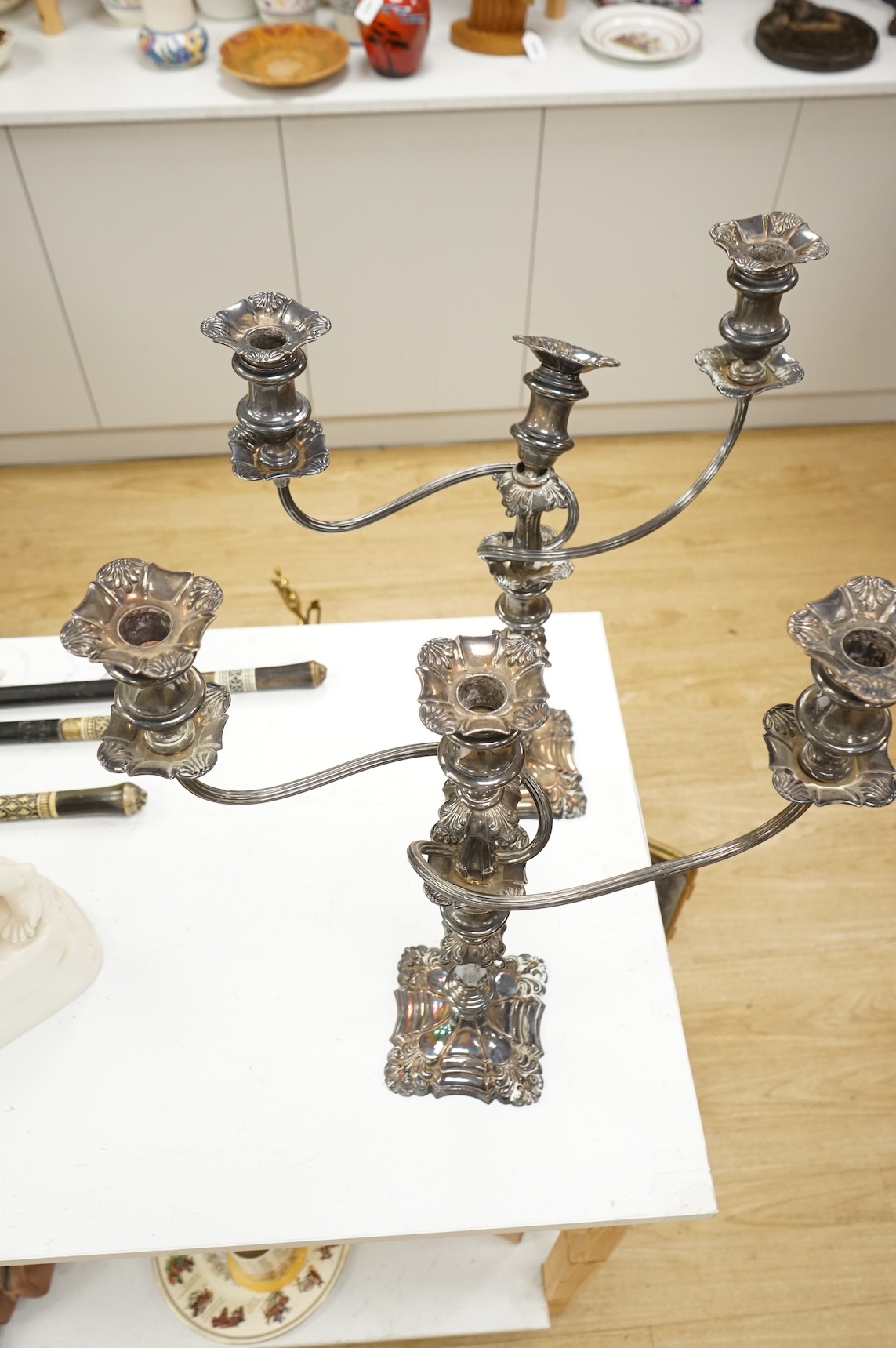 A pair of silver plated two branch three light candelabra, 53cm high